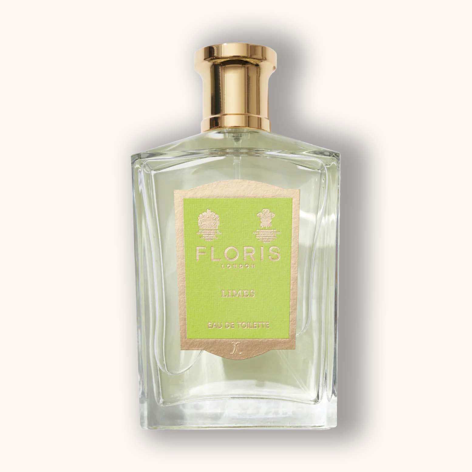 Alt text: A clear glass bottle of Floris London Limes Eau de Toilette, featuring a textured green label and gold cap, elegantly showcasing the refreshing citrus scent inside.