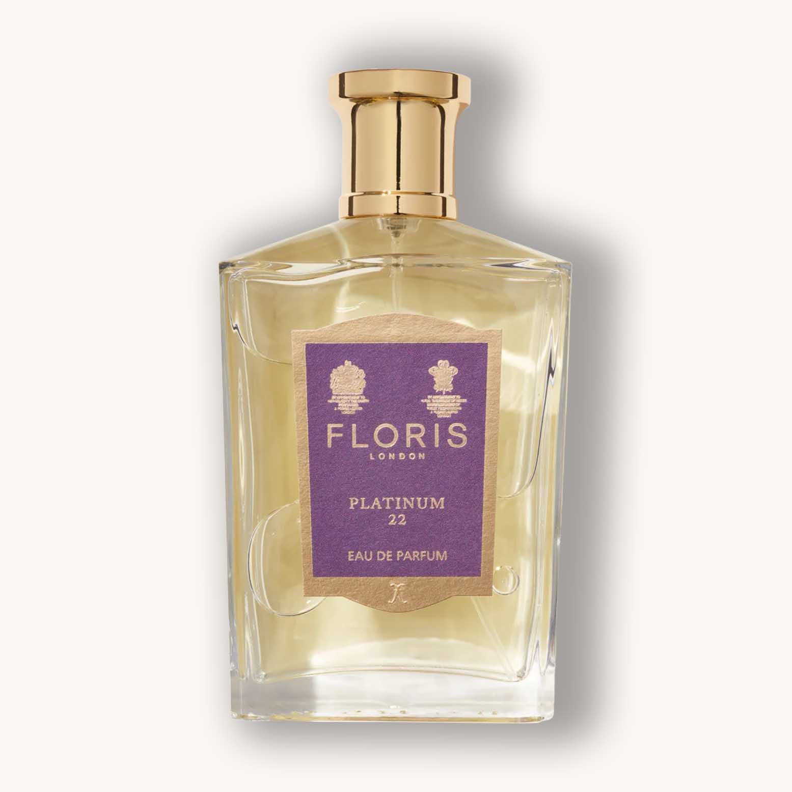 Alt text: A sleek glass bottle of Floris London Platinum 22 Eau de Parfum, featuring a gold cap and a distinctive purple label with elegant branding. The fragrance is showcased in a stylish and classic design.