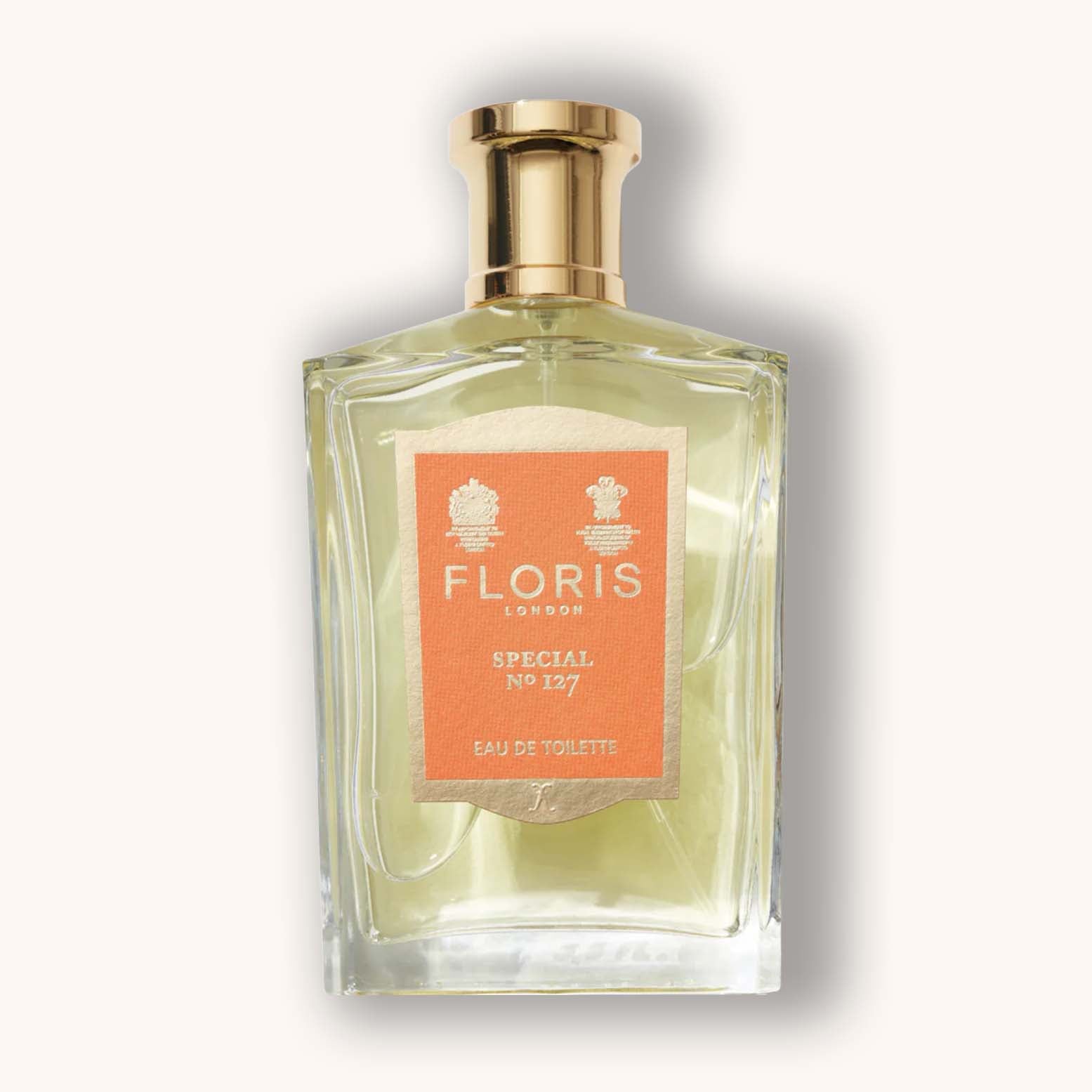 Alt text: A glass bottle of Floris London Special No. 127 Eau de Toilette, featuring an elegant design with a gold cap and a peach-colored label.