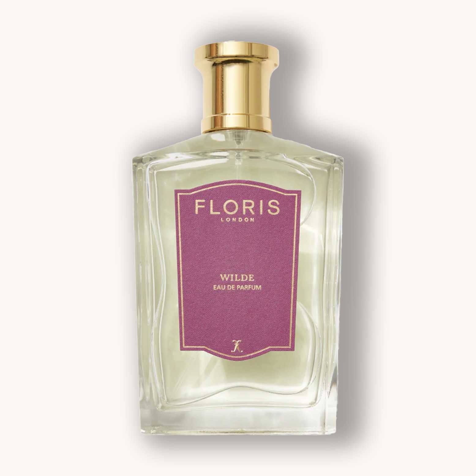 A clear glass bottle of Floris London Wilde Eau de Parfum, featuring an elegant shape and a gold cap, with a purple label prominently displaying the brand and fragrance name.