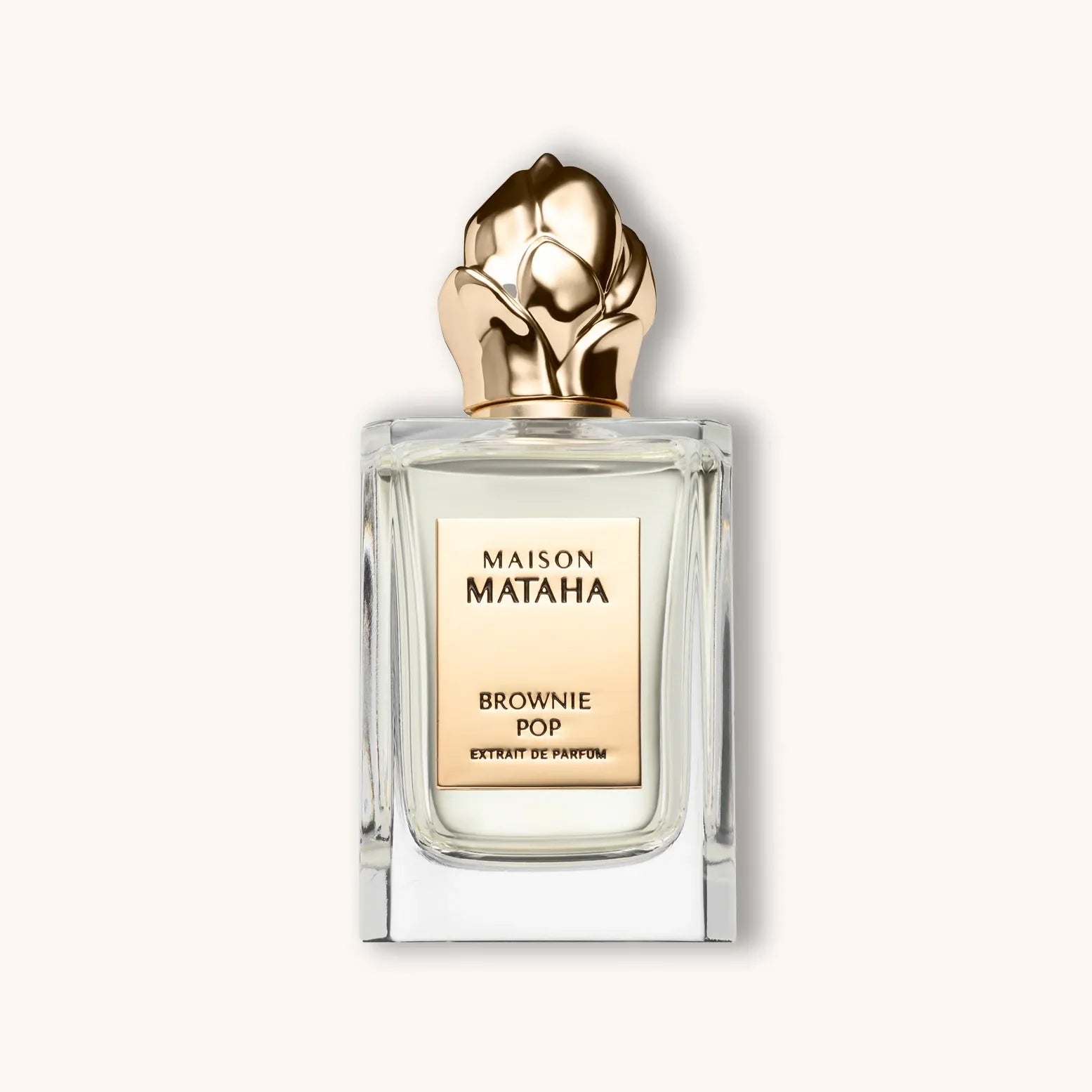 Flacon van Maison Mataha Brownie Pop Extrait de Parfum met gouden bloemvormige dop en elegante transparante en rechthoekige glazen fles.