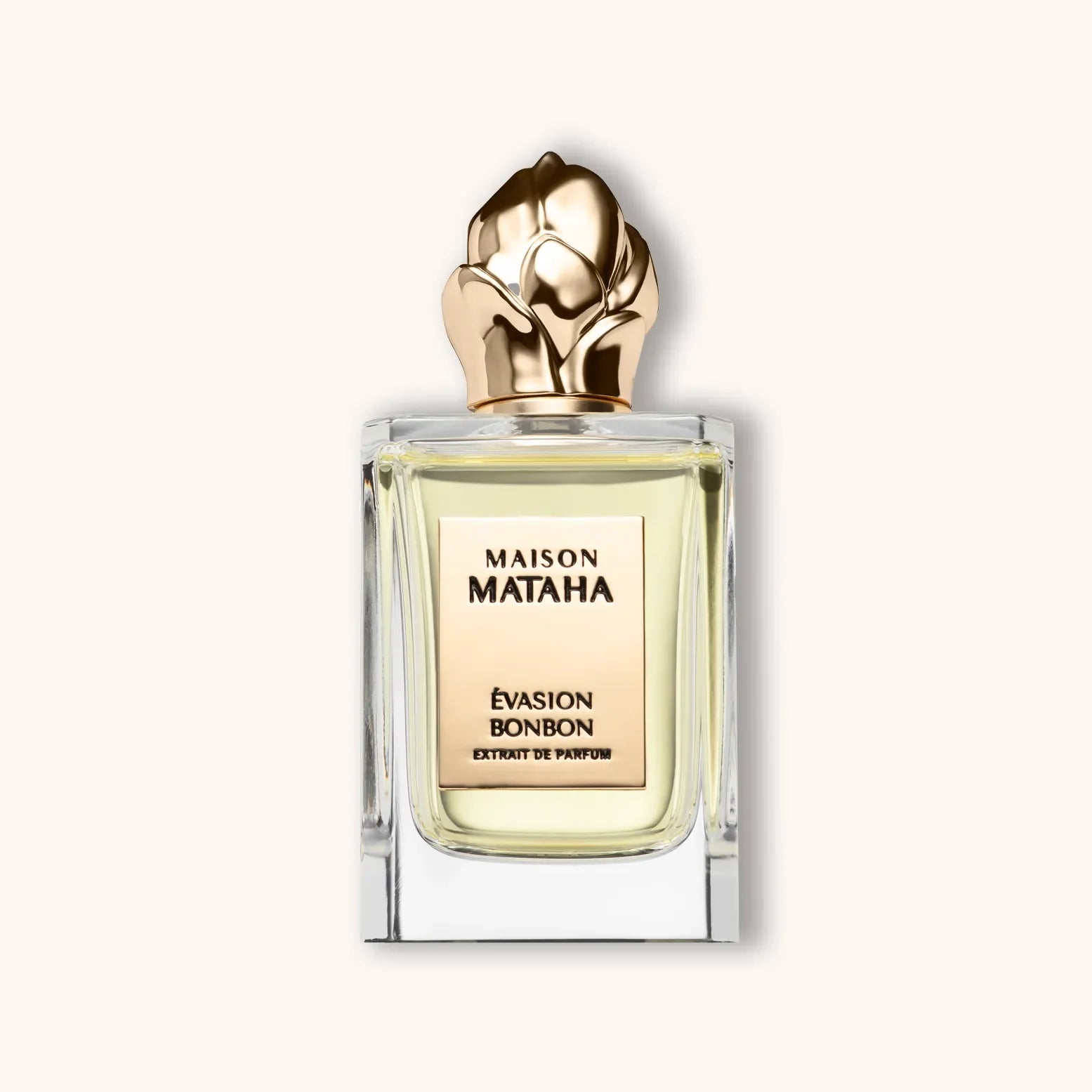 Flacon van Maison Mataha Evasion Bonbon, met geschreven op de flacon de naam en Extrait de Parfum. De fles heeft een gouden bloemvormige dop en elegante transparante glazen fles.