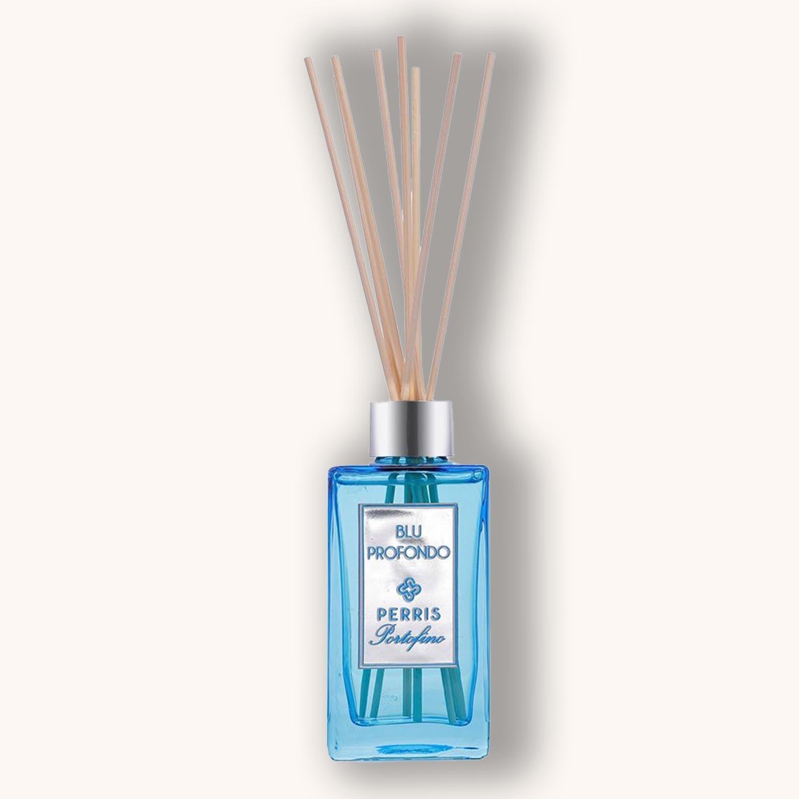 Alt text: "Perris Portofino Blu Profondo Home Diffuser in a clear blue glass bottle, featuring decorative reeds for fragrance release."