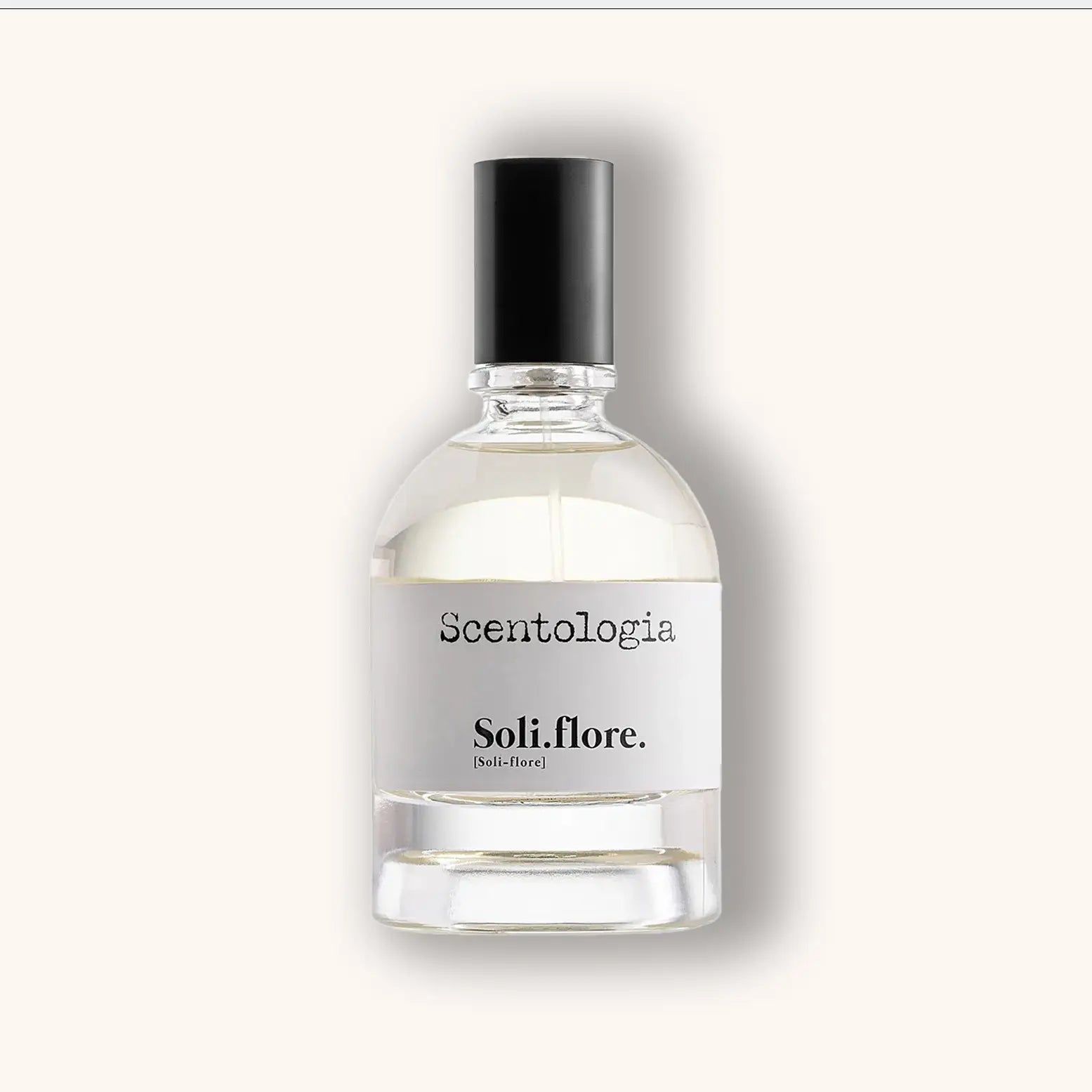 Heldere glazen flacon van Scentologia Soli.flore. Parfum Extrait, transparante vloeistof met wit label en zwarte typografie.