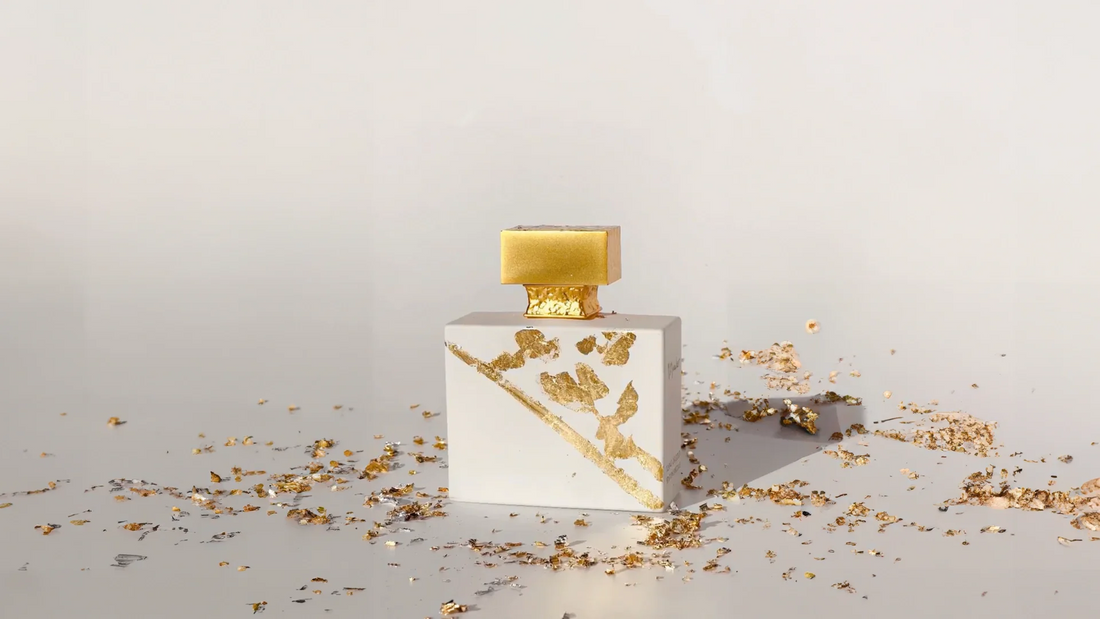 A bottle of Ylang in Gold by M. Micallef with shreds of golden paper