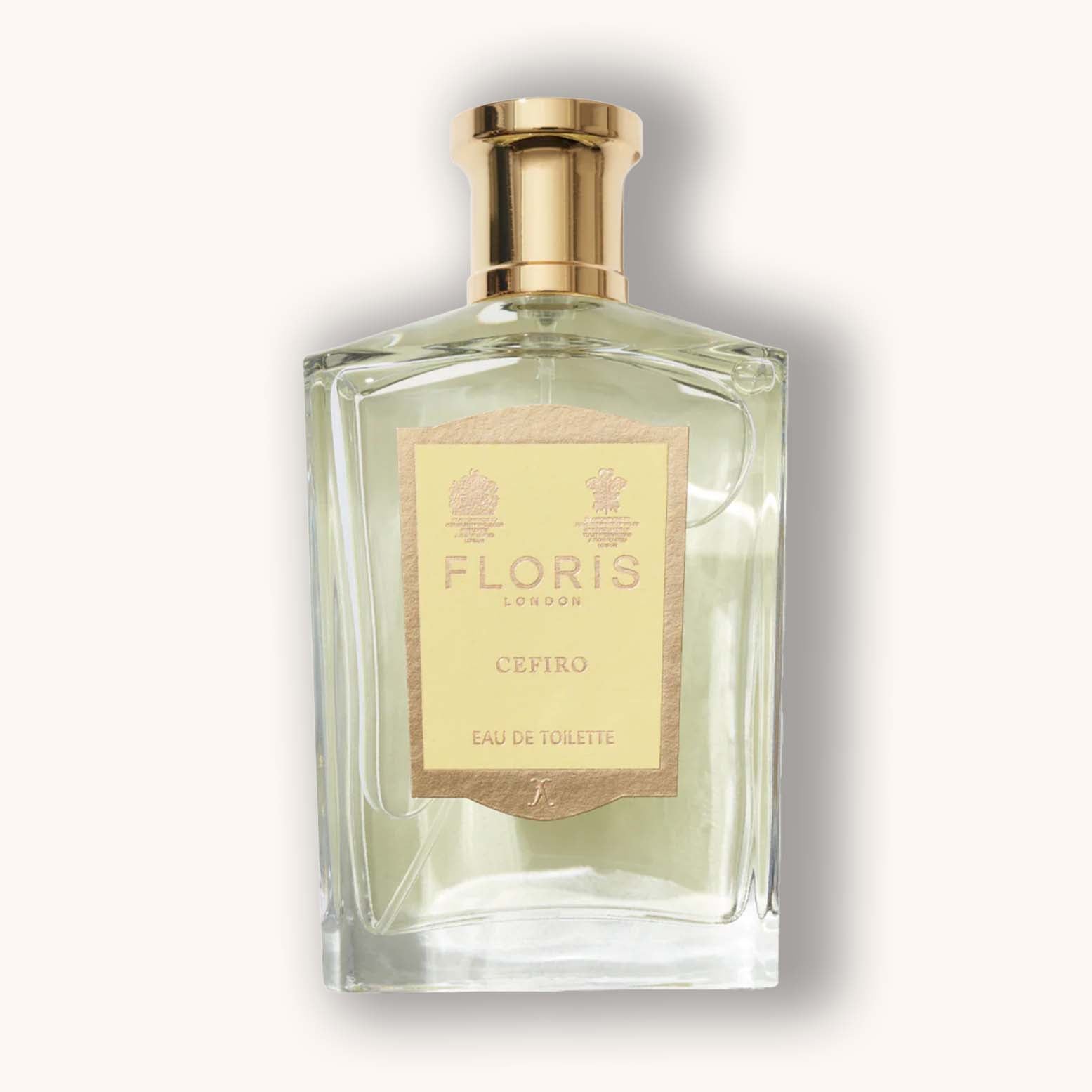 Alt text: A stylish glass bottle of Floris London Cefiro, featuring a gold cap and label, showcasing a light green fragrance inside.