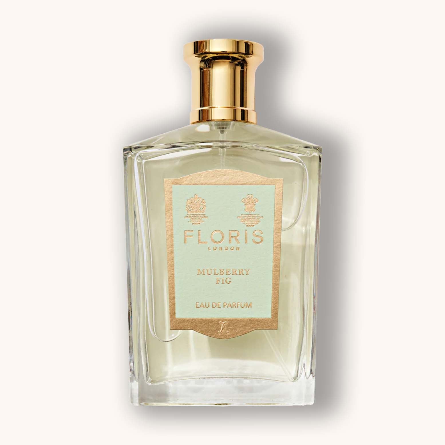 Alt text: A beautifully designed glass bottle of Floris London Mulberry Fig eau de parfum, featuring a gold cap and a pale blue label with elegant branding. The fragrance is presented in a classic, sophisticated style.