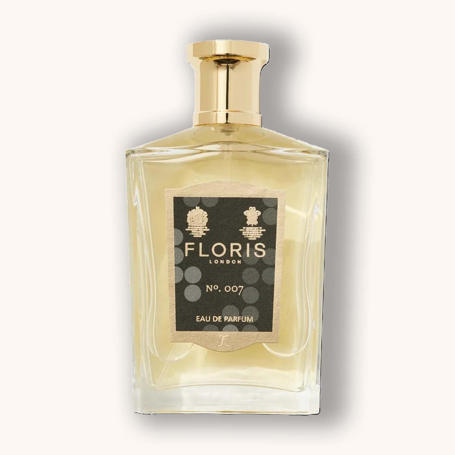 Alt text: A stylish glass bottle of Floris London No. 007 Eau de Parfum, featuring a gold cap and a distinctive label with circular patterns and elegant typography.