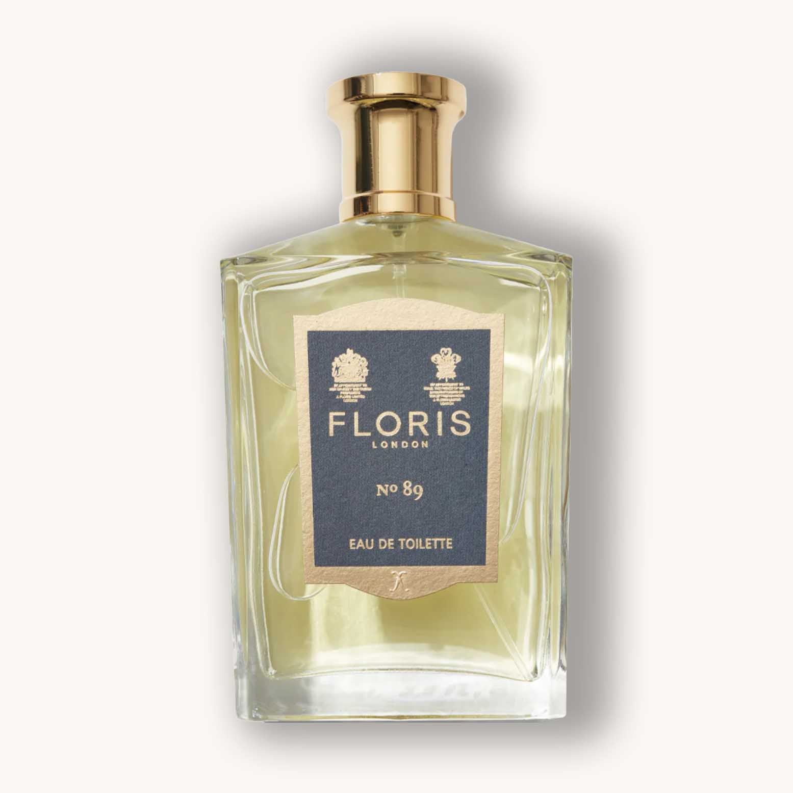Alt text: A clear glass bottle of Floris London No. 89 Eau de Toilette, featuring a rectangular design, gold cap, and a navy label with the brand name and product number prominently displayed.