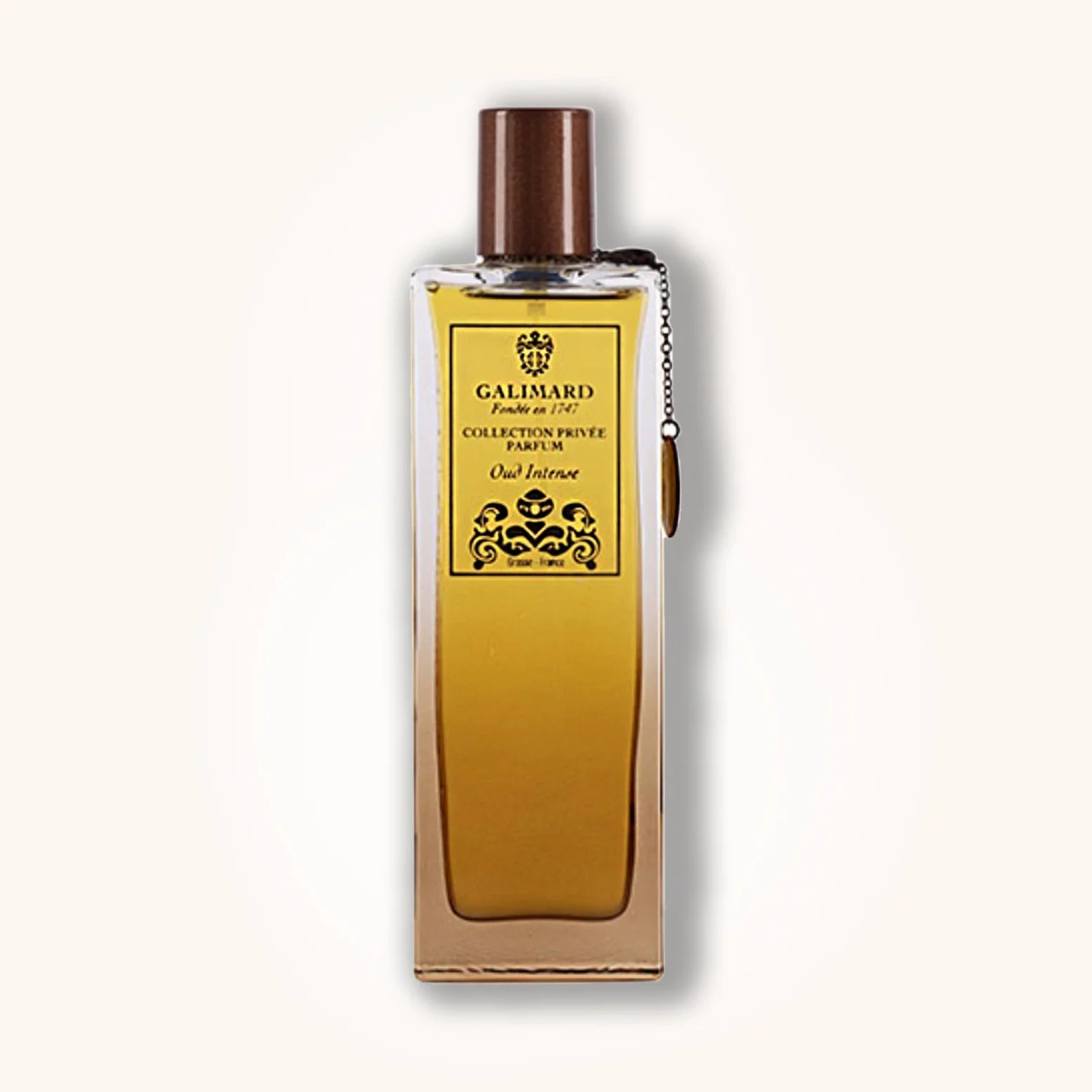 Oud Intense by Galimard in a rich golden-yellow bottle with brown cap and high-end black and gold label.