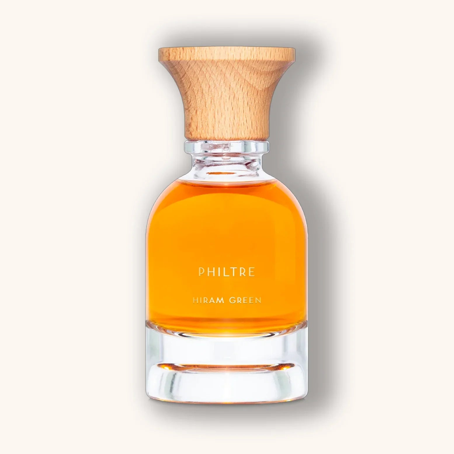 Philtre van Hiram Green, gepresenteerd in een glazen flacon met levendig oranje vloeistof en houten dop.