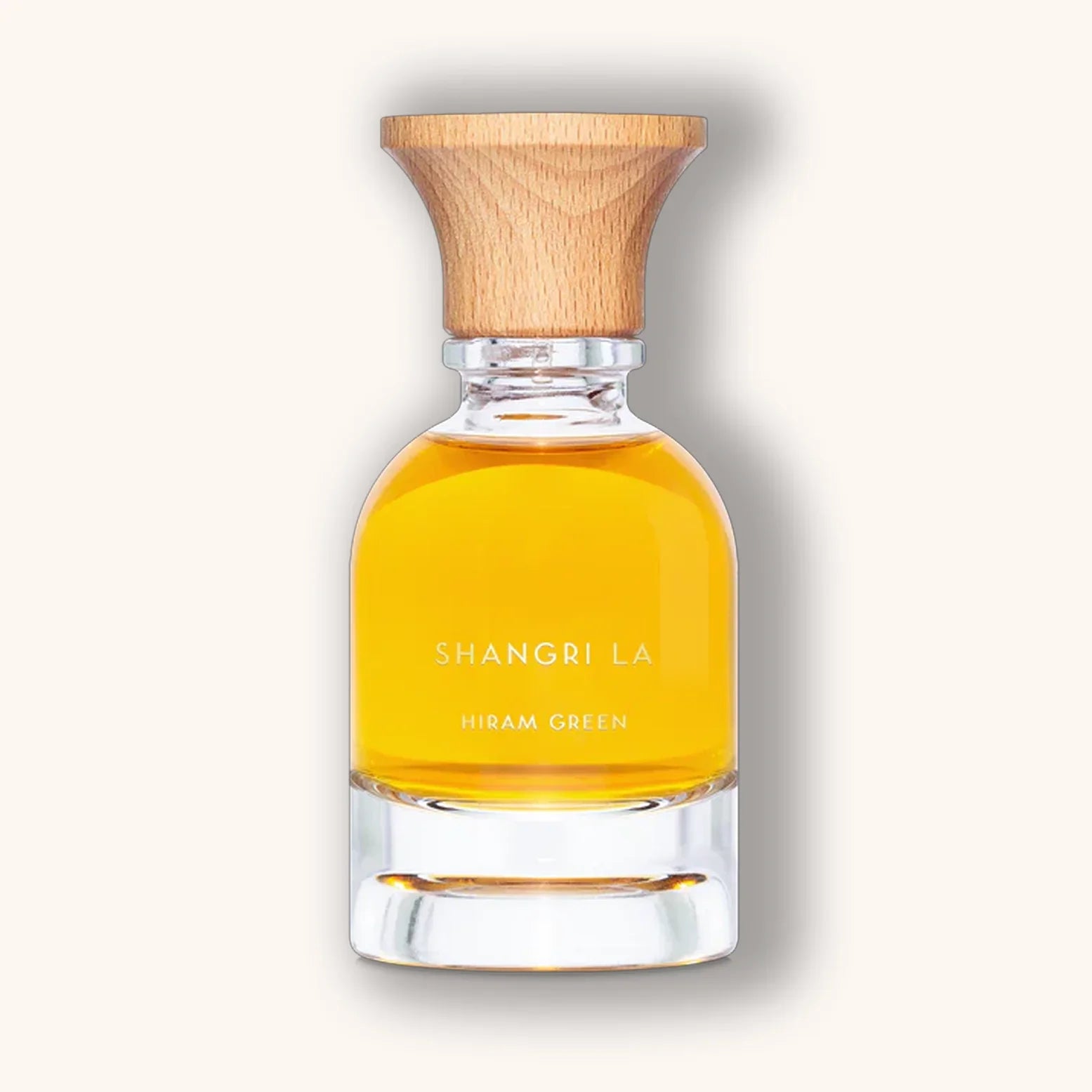 Hiram Green Shangri La parfumflacon met goudgele vloeistof en een minimalistisch ontwerp met houten dop.