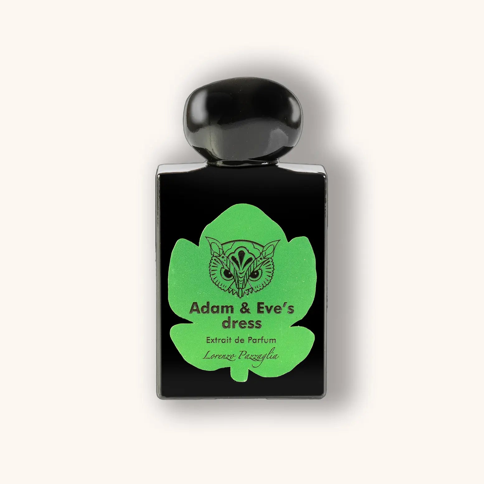 Zwart parfumflesje met groene vijgenbladvormige opdruk en het label "Adam & Eve’s Dress" van Lorenzo Pazzaglia – een luxueus uniseks extrait de parfum.