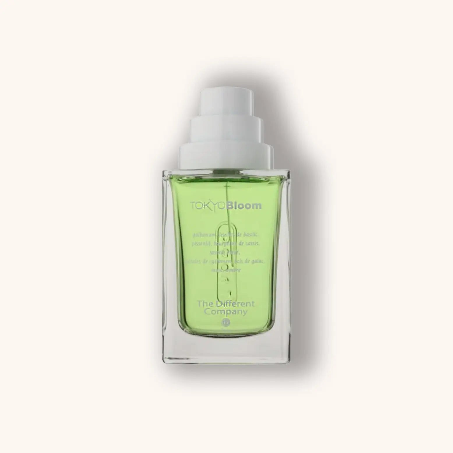 Alt text: A sleek glass bottle of 'The Different Company Tokyo Bloom' featuring a vibrant green liquid inside. The minimalist design emphaInhouds the product's freshness and elegance.