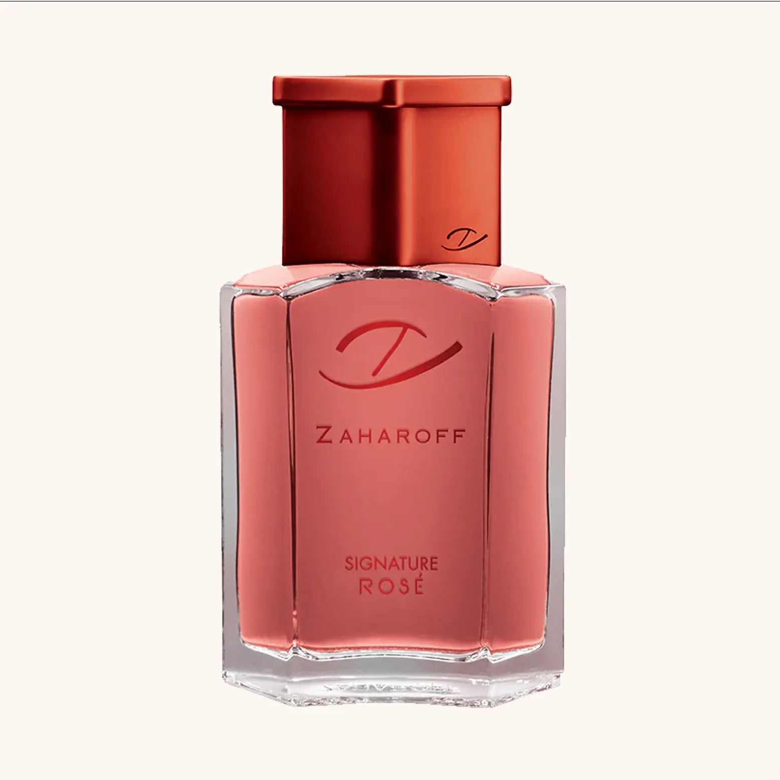 Een fles Zaharoff Signature Rosé parfum met een elegante zeshoekige glazen fles en een roségouden vloeistof. De fles heeft een rood metalen dop en het Zaharoff-logo en de tekst “Zaharoff Signature Rosé” staan op de voorkant.